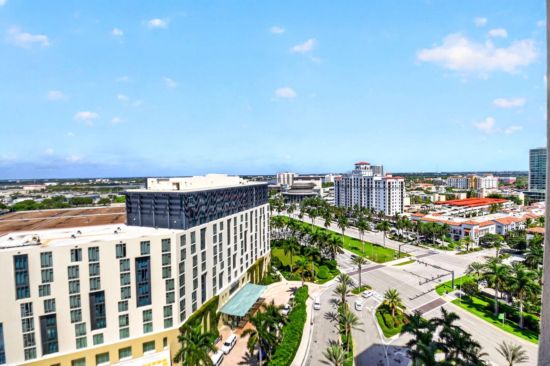 550 OKEECHOBEE Boulevard, #1618, West Palm Beach, West Palm Beach, FL 33401 Expansive urban landscape with multiple high-rise buildings, mature palm trees, and clear blue skies