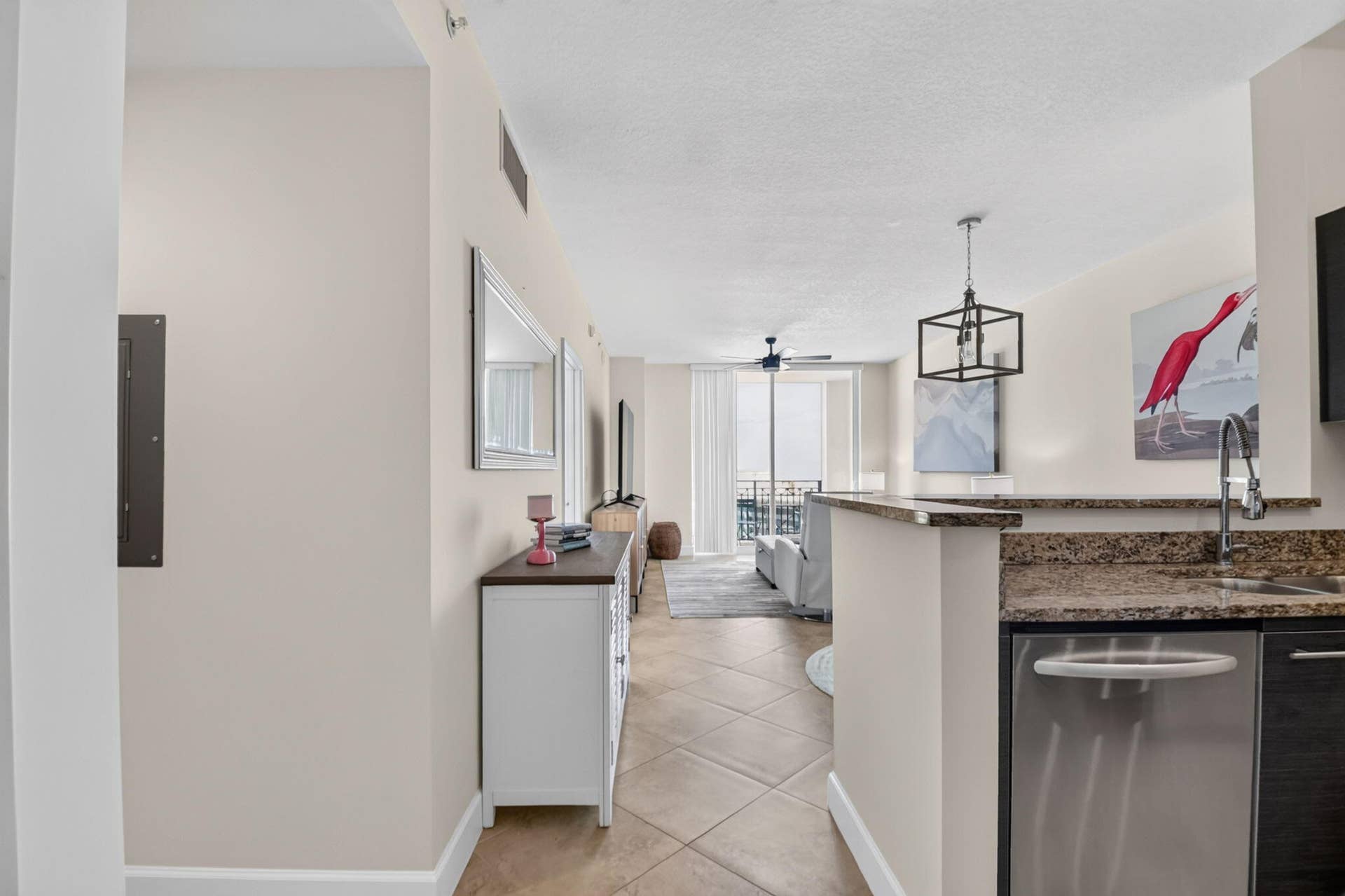 550 OKEECHOBEE Boulevard, #1618, West Palm Beach, West Palm Beach, FL 33401 Tiled flooring throughout, kitchen featuring a stainless steel dishwasher, granite countertops, and a contemporary pendant light fixture