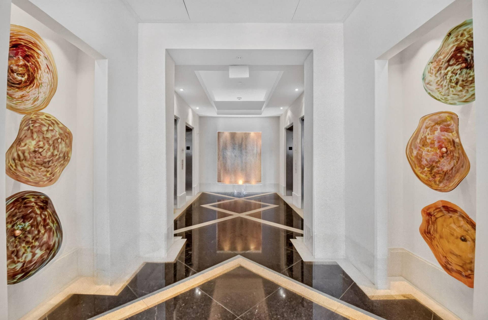 550 OKEECHOBEE Boulevard, #1618, West Palm Beach, West Palm Beach, FL 33401 Hallway with geometric patterned floor tiling, recessed wall alcoves, and integrated ceiling lighting