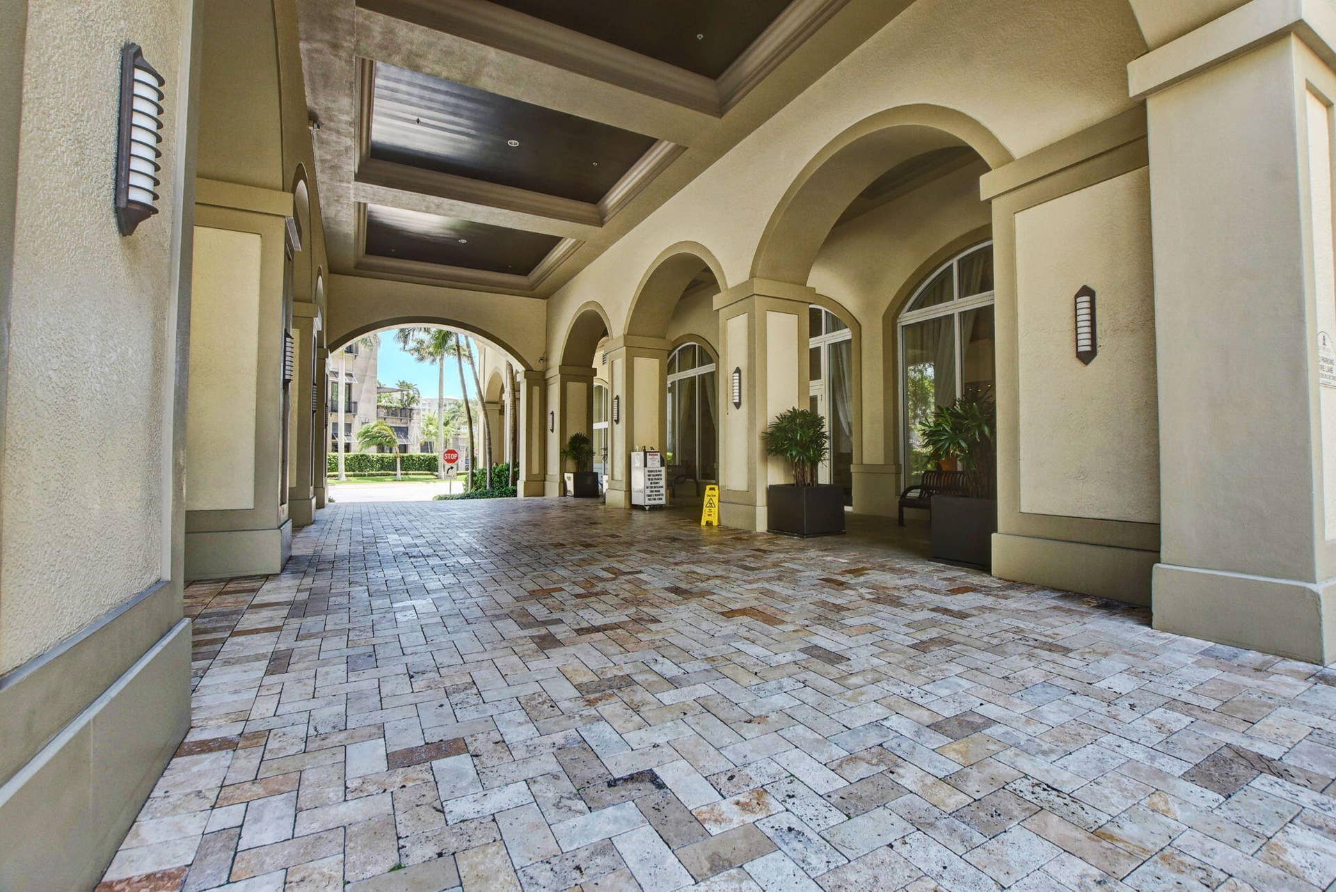 550 OKEECHOBEE Boulevard, #1618, West Palm Beach, West Palm Beach, FL 33401 Covered entryway featuring arched openings, patterned stone-finish flooring, and recessed ceiling lighting