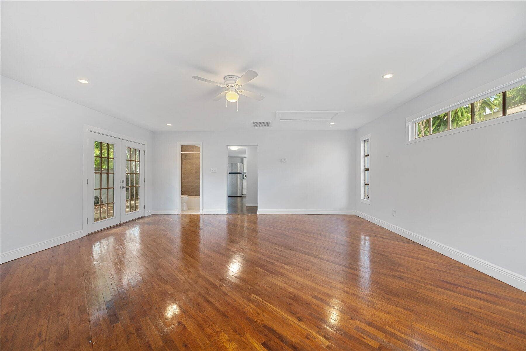 714 W Lakewood Road, #B, West Palm Beach, West Palm Beach, FL 33405 Hardwood flooring, recessed lighting, white ceiling fan, French doors with divided lites, and clerestory windows