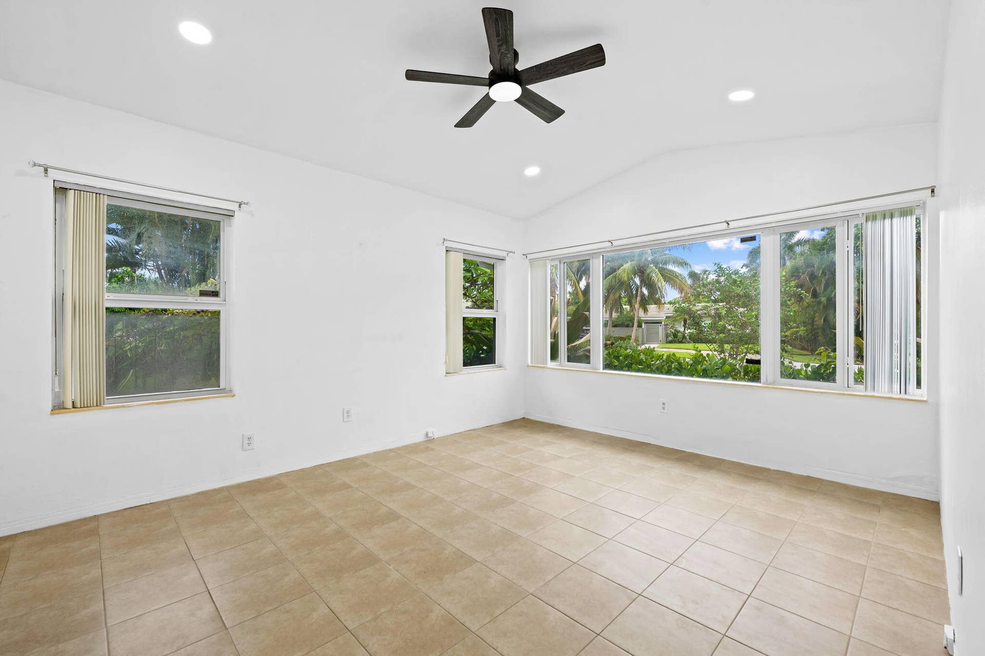1705 NE 26TH Avenue, Fort Lauderdale, FL 33305 Vaulted ceiling, recessed lighting, ceiling fan, tile flooring, and multiple windows