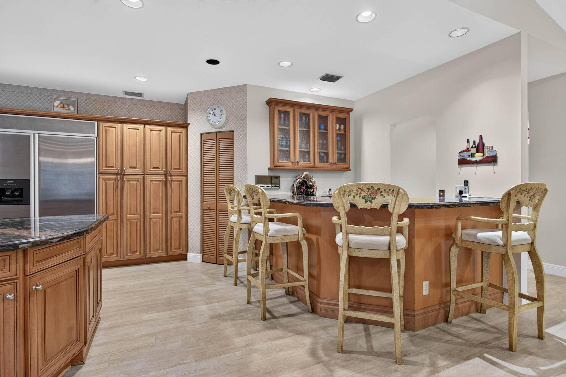 10240 Vestal Court, Coral Springs, FL 33071 Walk-in pantry. Wet bar with beverage refrigerator matching kitchen cabinetry and granite
