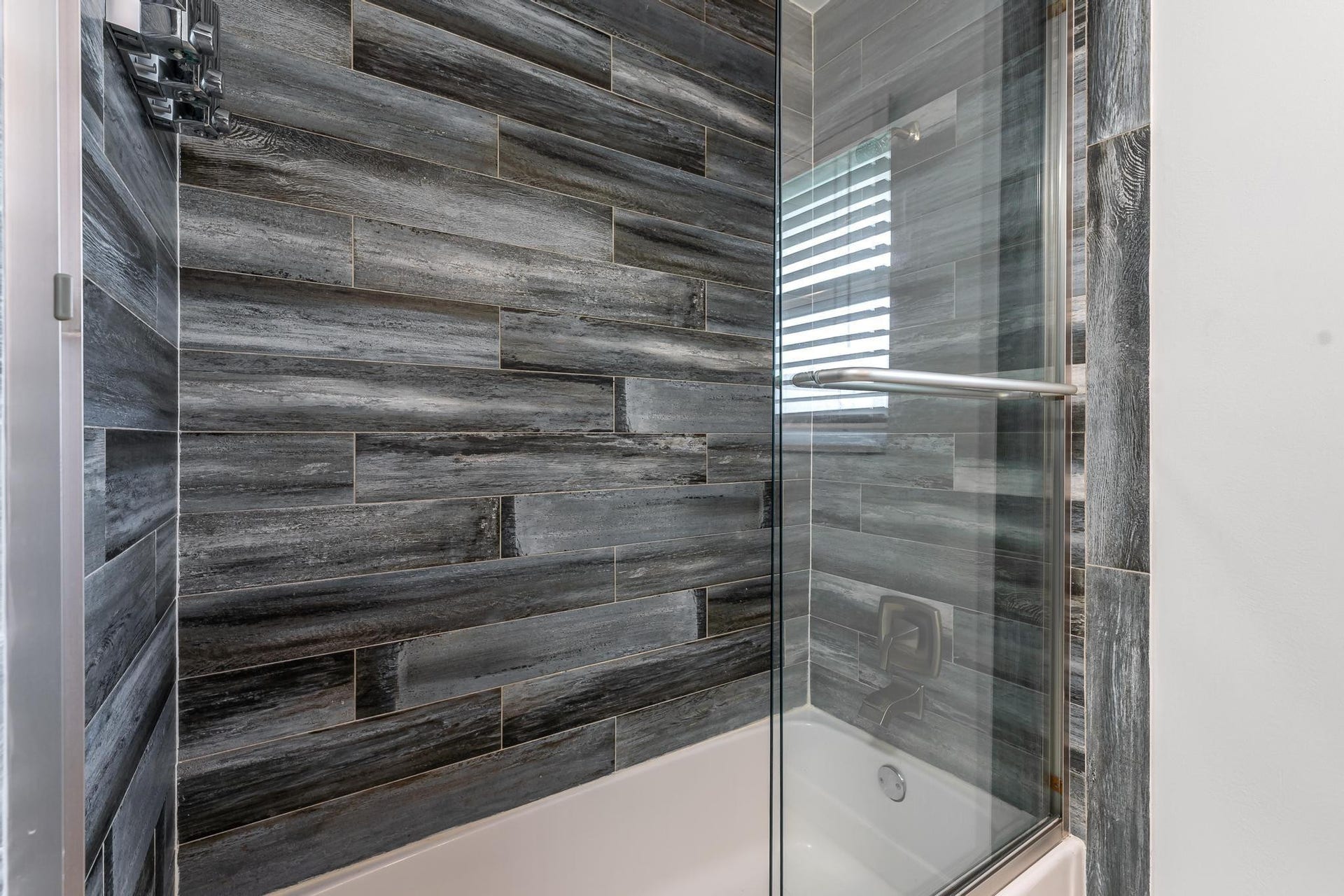 Tiled tub and shower with glass door