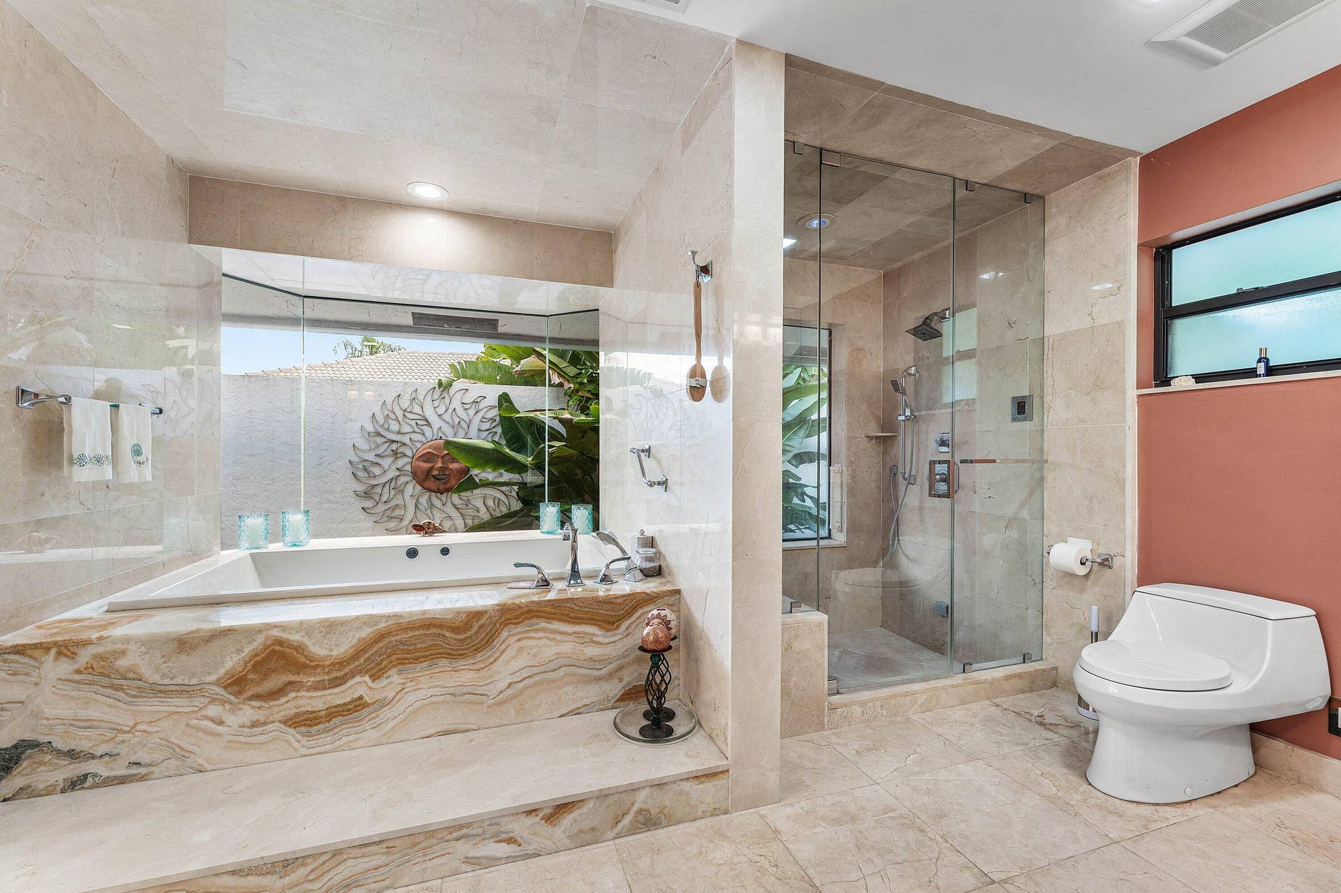 56 NORTHWOODS Lane, Boynton Beach, FL 33436 Soaking tub with a natural stone surround, a walk-in shower with a glass enclosure, and a wall-mounted toilet