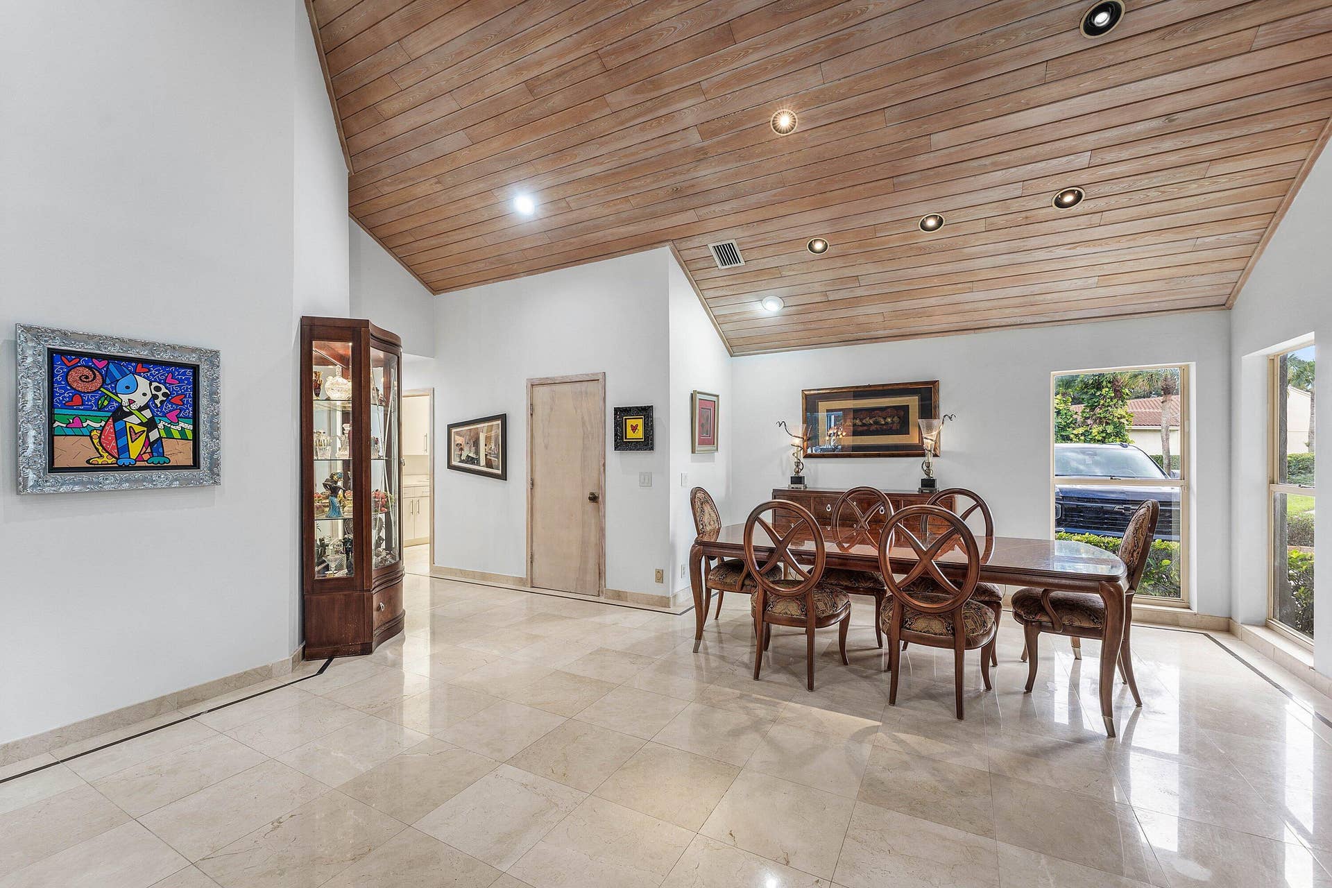 56 NORTHWOODS Lane, Boynton Beach, FL 33436 Vaulted wood-paneled ceiling with recessed lighting, light-toned stone tile flooring, and multiple windows providing natural illumination