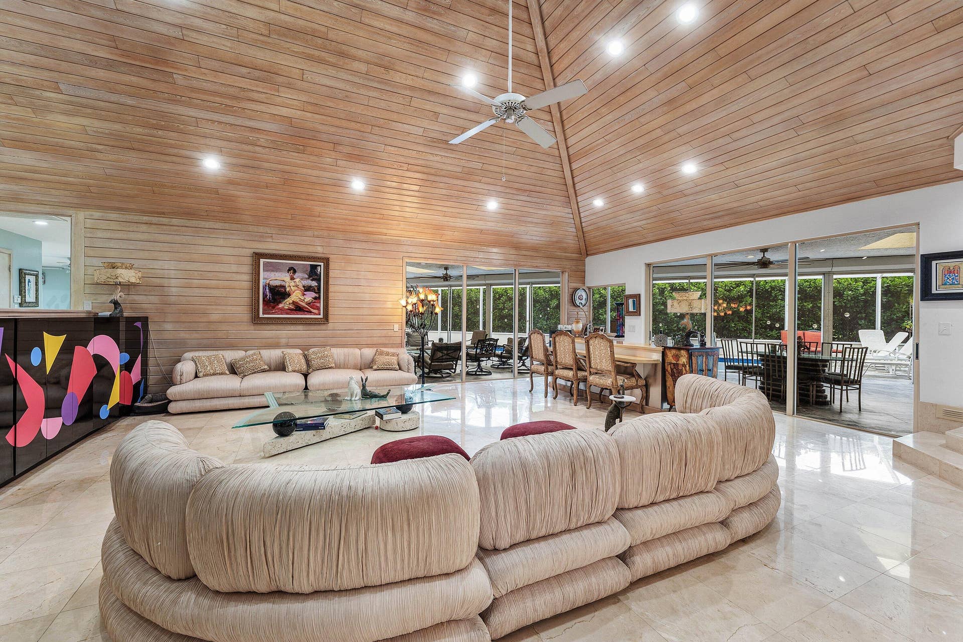 56 NORTHWOODS Lane, Boynton Beach, FL 33436 Vaulted wood-paneled ceiling with recessed lighting, large format tile flooring, and extensive glass sliding doors overlooking exterior