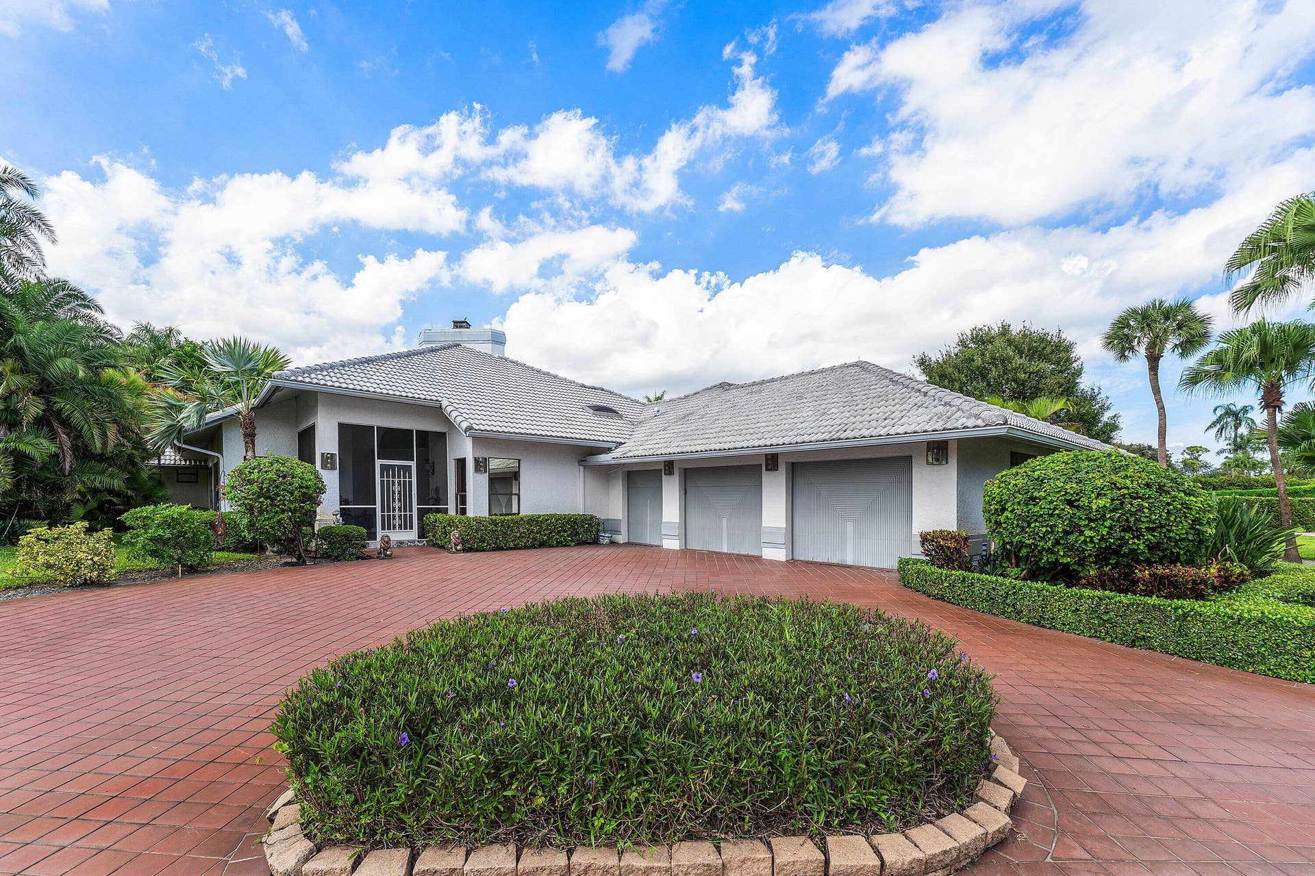 56 NORTHWOODS Lane, Boynton Beach, FL 33436 White exterior with a grey tile roof and a screened entry