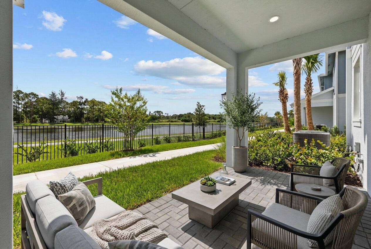 Covered patio featuring paver flooring, a perimeter fence, and direct water access