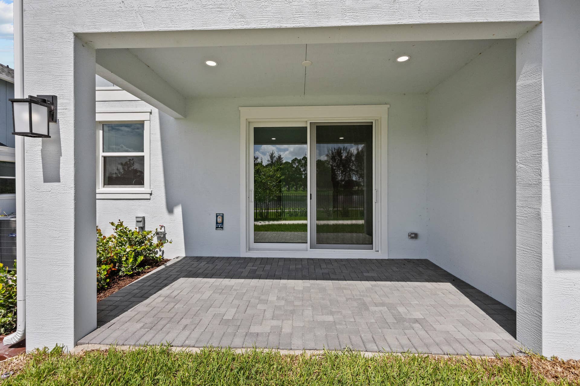 Covered patio featuring paver flooring
