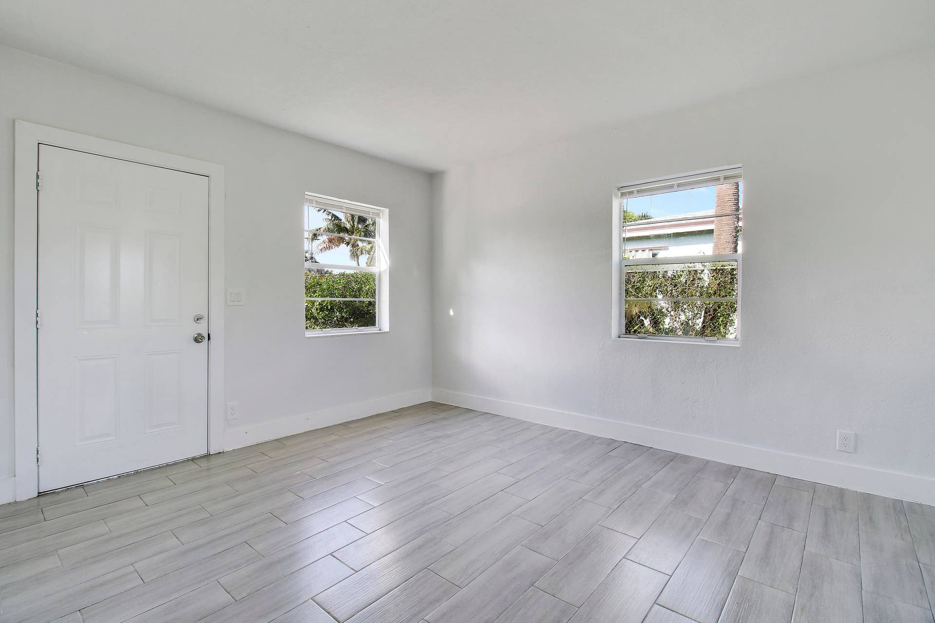 Crisp white walls, two windows providing natural illumination,