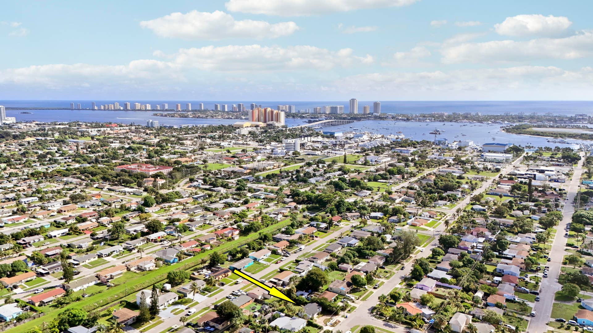 Aerial perspective of a residential neighborhood with distant coastal waters