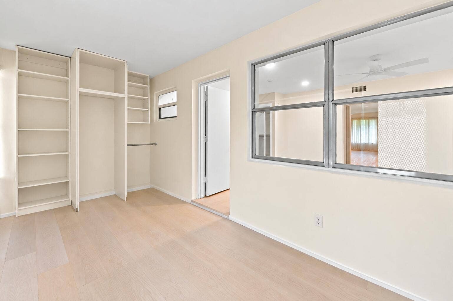 Decluttered sunroom with empty shelves