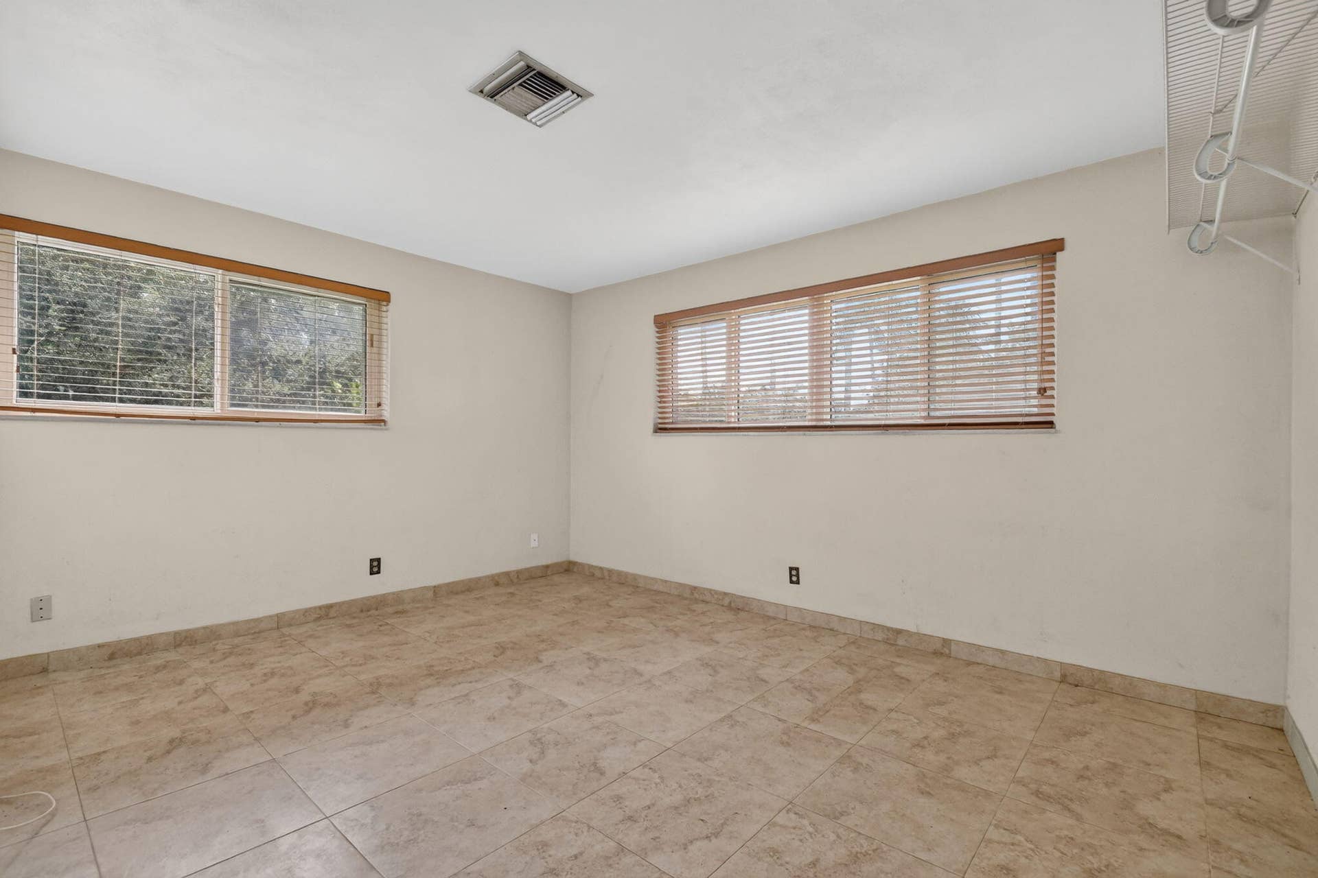 Tile flooring throughout, ample natural light from multiple windows, and a built-in closet organization system