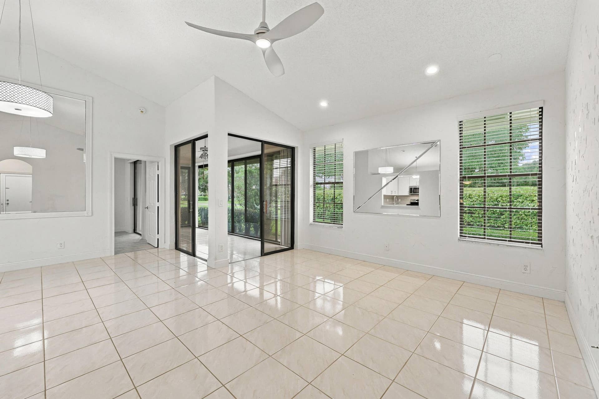 8292 WATERLINE Drive, #106, Boynton Beach, FL 33472 Vaulted ceilings, recessed lighting, ceiling fan, and large windows with blinds