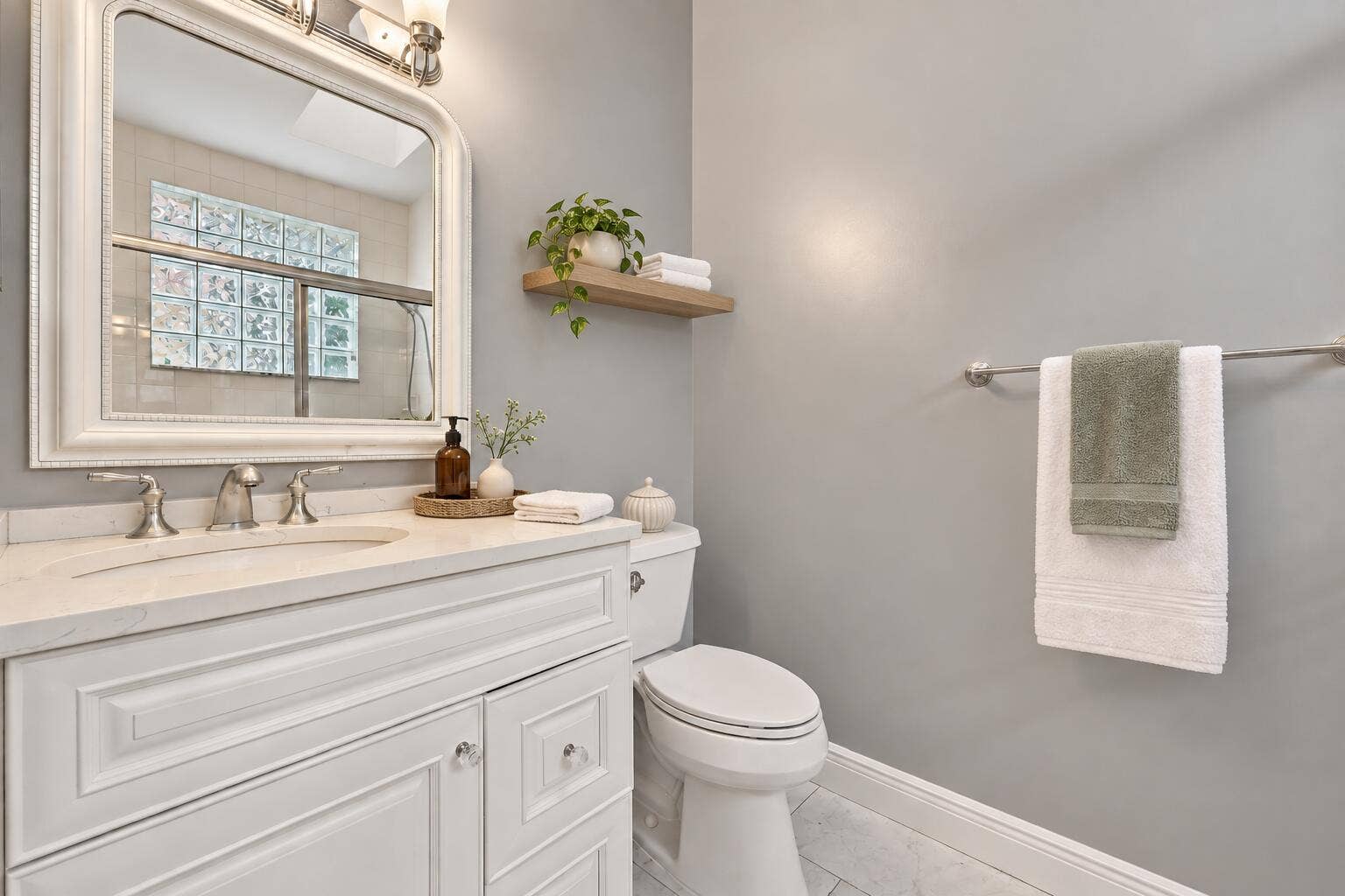 8292 WATERLINE Drive, #106, Boynton Beach, FL 33472 White vanity with paneled doors and crystal knobs, light-toned countertop, and undermount sink with brushed nickel faucet