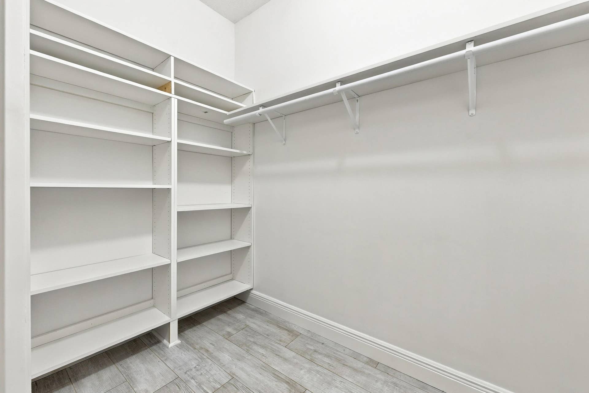 8292 Waterline Drive, #106, Boynton Beach, FL 33472 Built-in shelving and hanging rods with wood-finish flooring