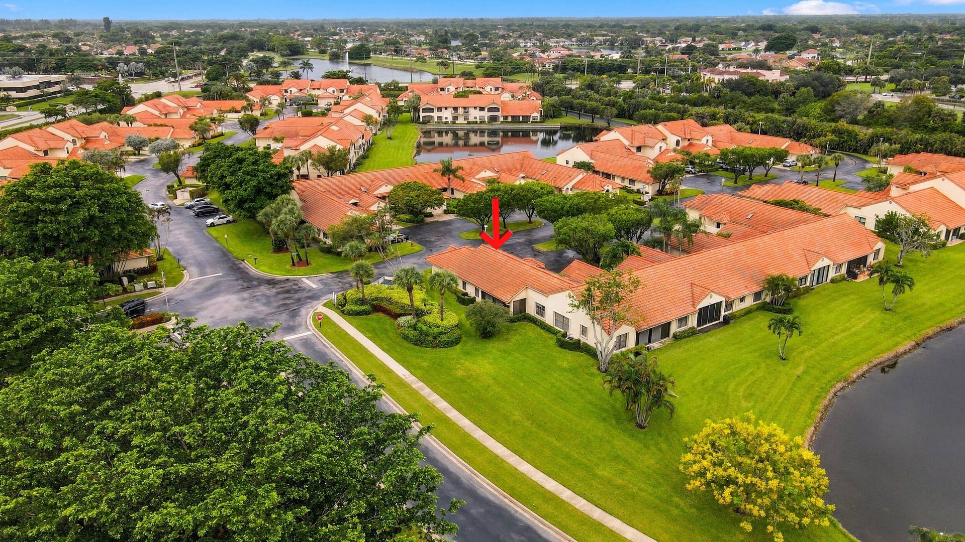 8292 Waterline Drive, #106, Boynton Beach, FL 33472 Community with terracotta-style roofs, surrounded by manicured green spaces and mature trees
