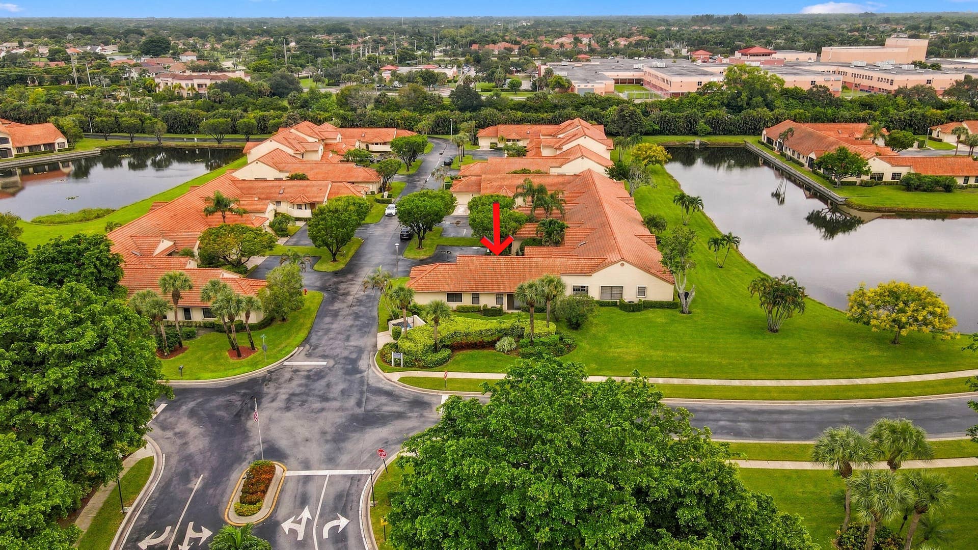 8292 Waterline Drive, #106, Boynton Beach, FL 33472 Community with multiple bodies of water, terracotta rooflines, and mature landscaping