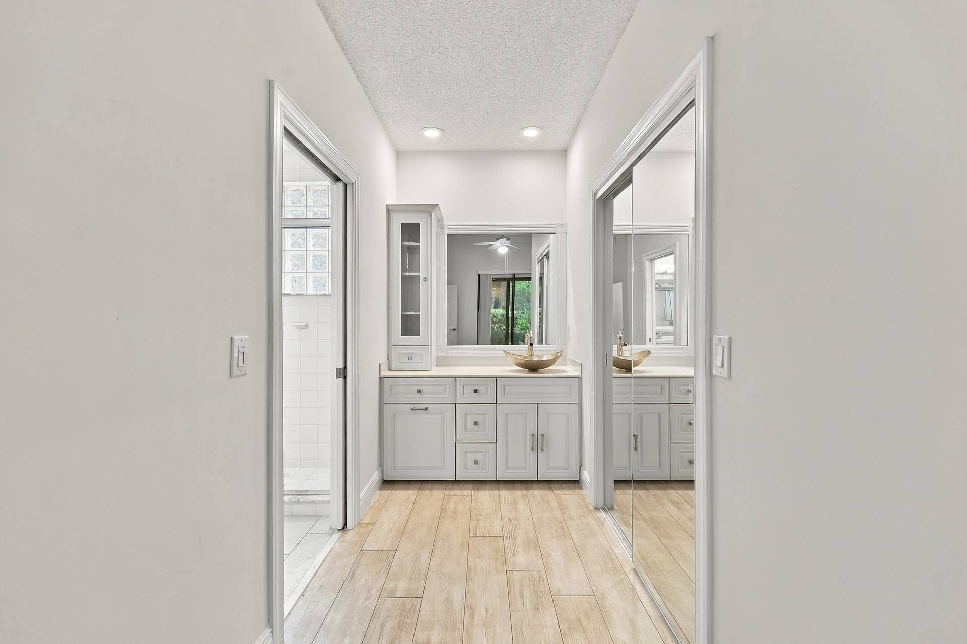 8292 Waterline Drive, #106, Boynton Beach, FL 33472 Hallway with wood-finish flooring, recessed lighting, white walls, and mirrored closet doors
