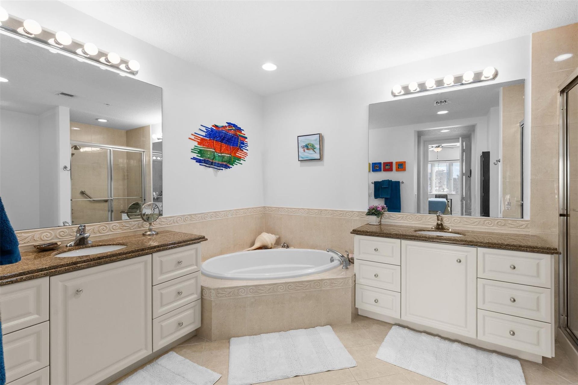 9 HARBOUR ISLE Drive E, #102, Fort Pierce, FL 34949 Primary bath features dual vanities, deep soaking tub, and separate walk-in shower.