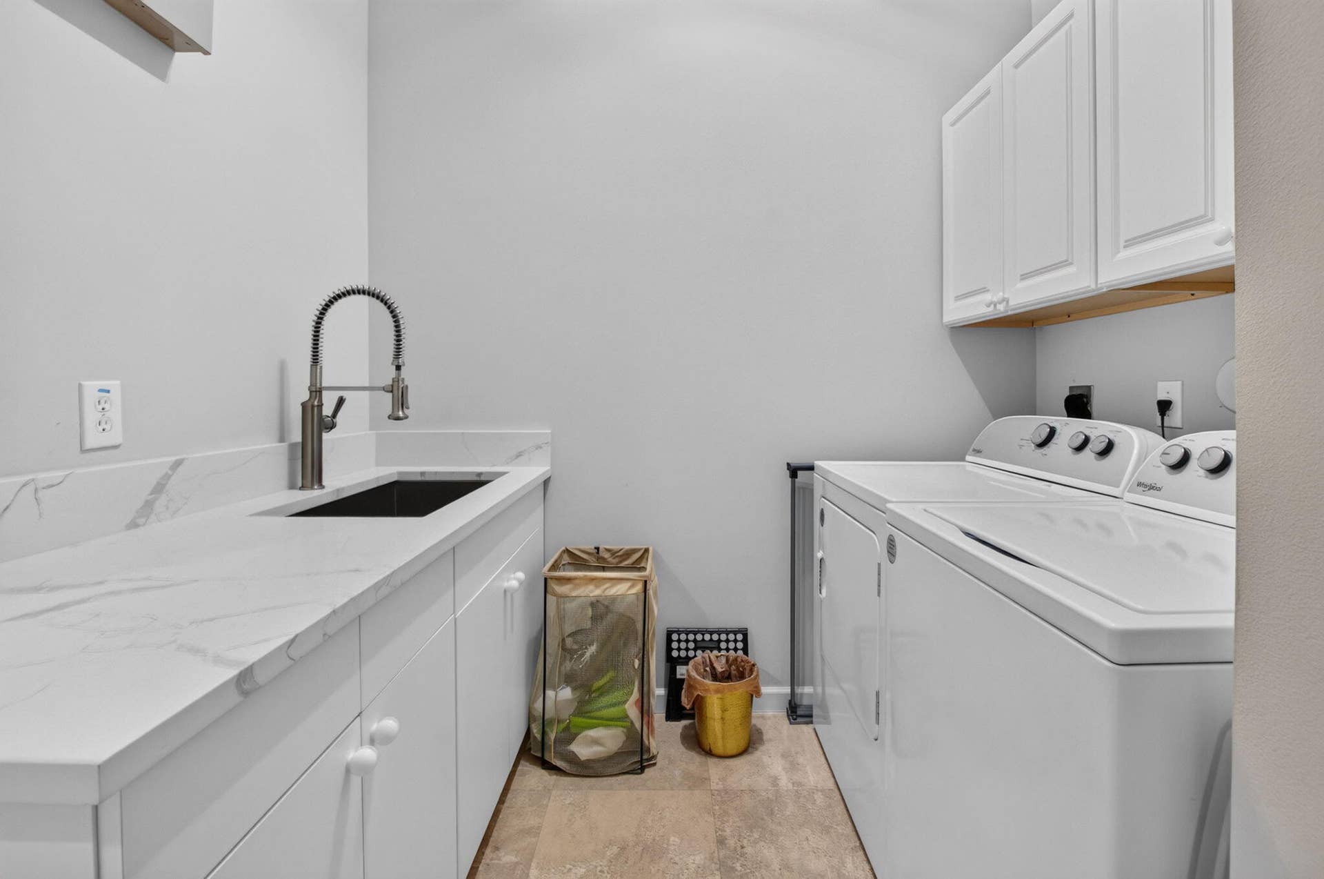 6610 Aston Lane, Boynton Beach, FL 33437 Full-size washer and dryer, white shaker cabinetry, white countertop with integrated sink, and a modern pull-down faucet