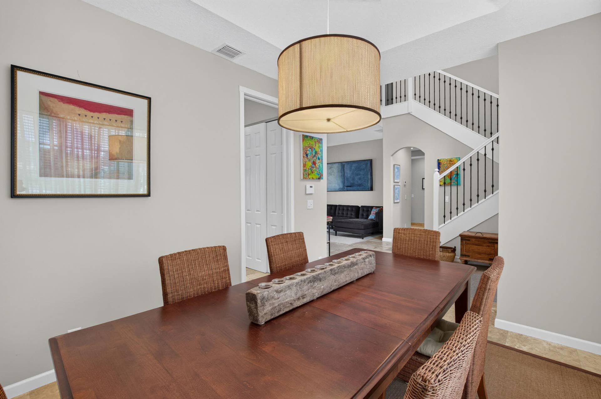 6610 Aston Lane, Boynton Beach, FL 33437 Tray ceiling with a drum pendant light fixture, wood-finish flooring, and white painted balusters