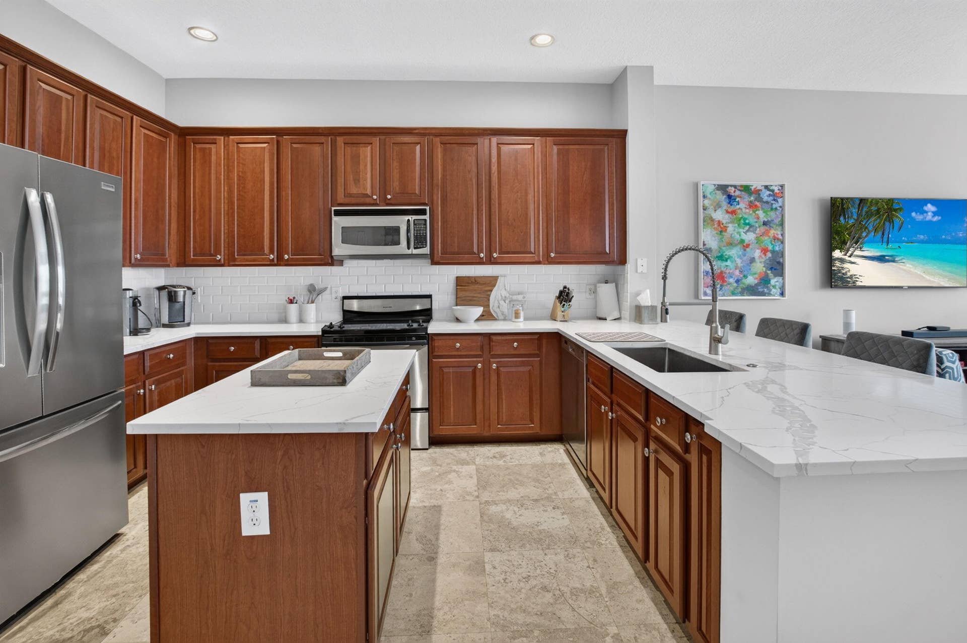 6610 Aston Lane, Boynton Beach, FL 33437 U-shaped kitchen featuring wood cabinetry, white subway tile backsplash, and stone-finish flooring
