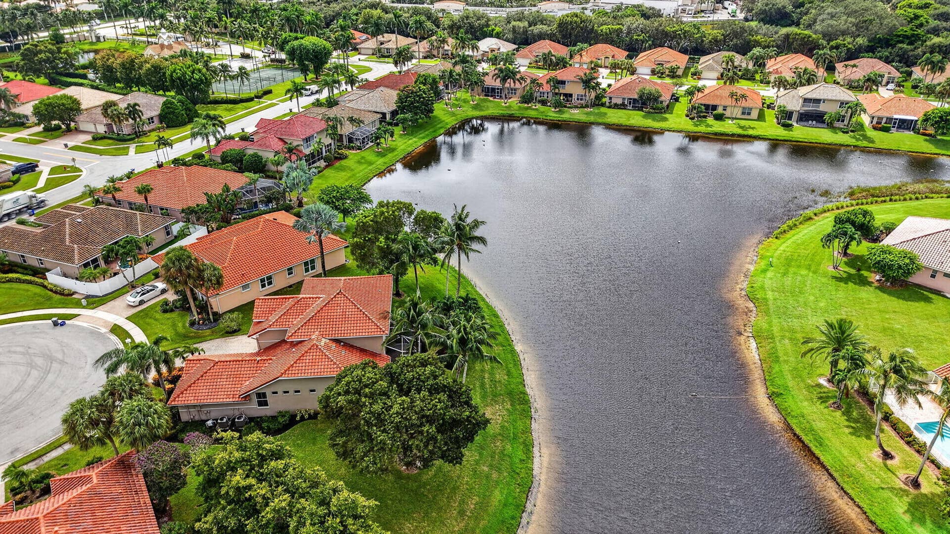 6610 Aston Lane, Boynton Beach, FL 33437 Lakeside community featuring lush landscaping, residential cul-de-sacs, and terracotta tile roofs