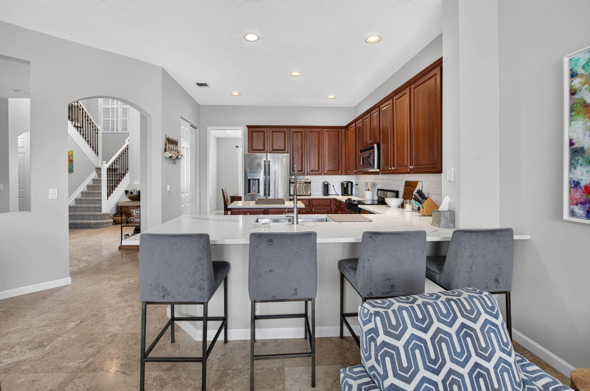 6610 Aston Lane, Boynton Beach, FL 33437 Kitchen featuring wood cabinetry, stainless steel appliances, and a light-toned backsplash