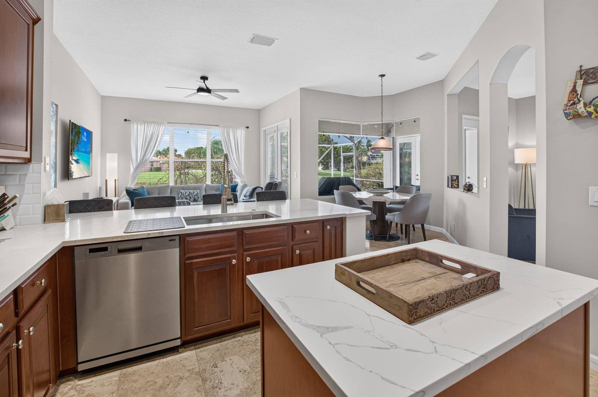 6610 Aston Lane, Boynton Beach, FL 33437 Kitchen featuring white quartz countertops, wood cabinetry, stainless steel dishwasher, and a dual basin sink with a high-arc faucet