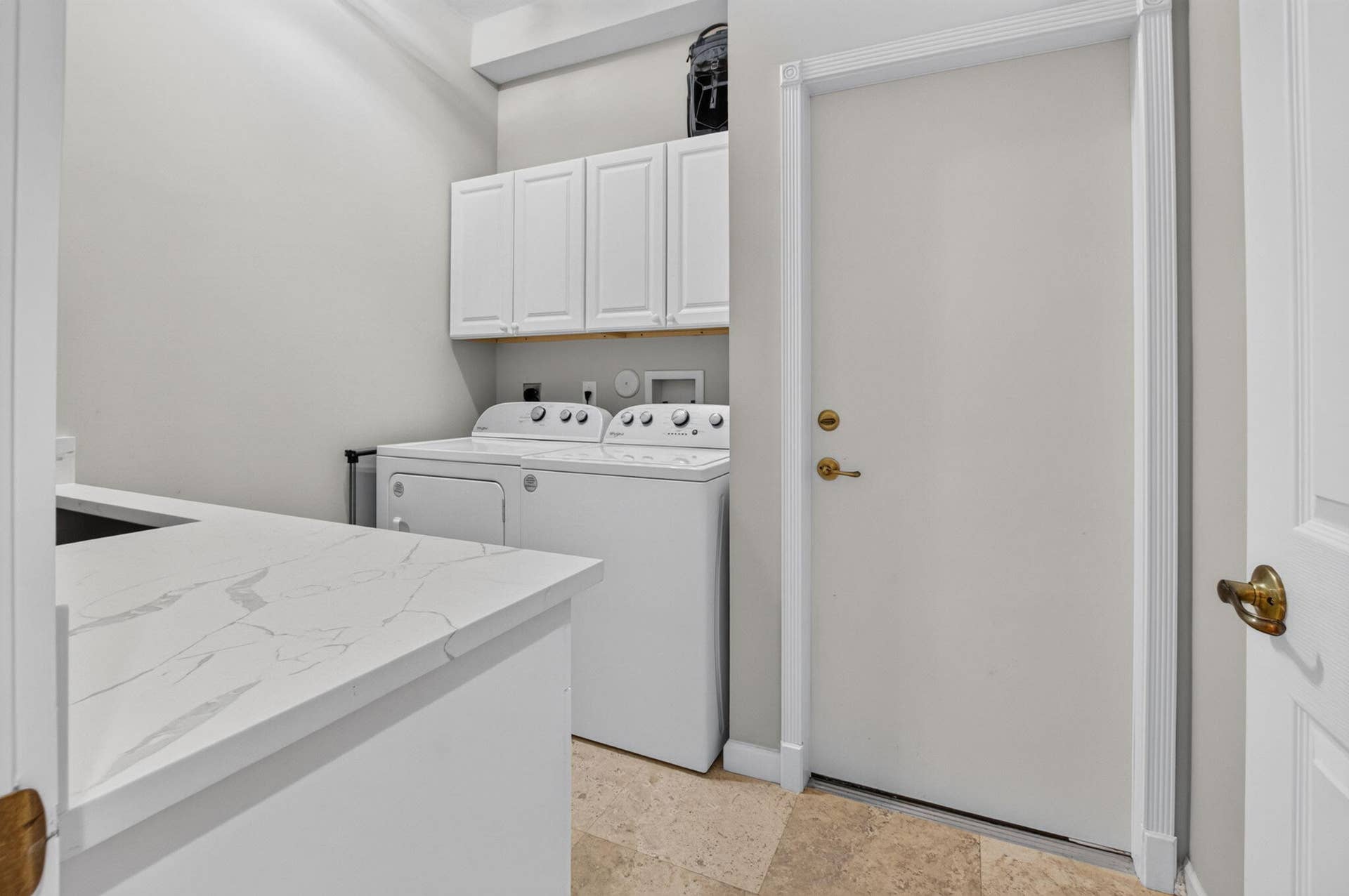 6610 Aston Lane, Boynton Beach, FL 33437 White Quartz cabinetry, stone-finish flooring, and a countertop with subtle veining