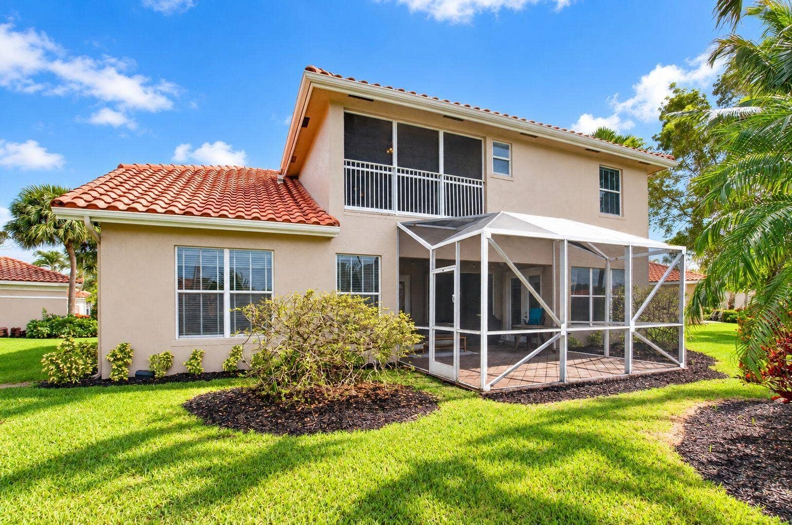 6610 Aston Lane, Boynton Beach, FL 33437 Exterior Expanded screened patio with paver flooring, upper-level screened balcony, and stucco finish