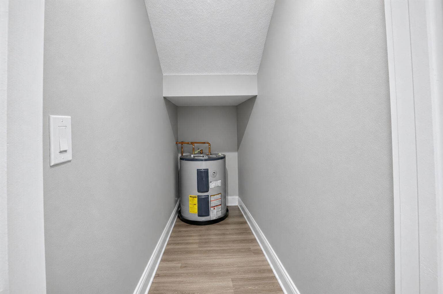 6610 Aston Lane, Boynton Beach, FL 33437 Extra Storage Closet...Water heater installation with light wood-finish flooring and white trim