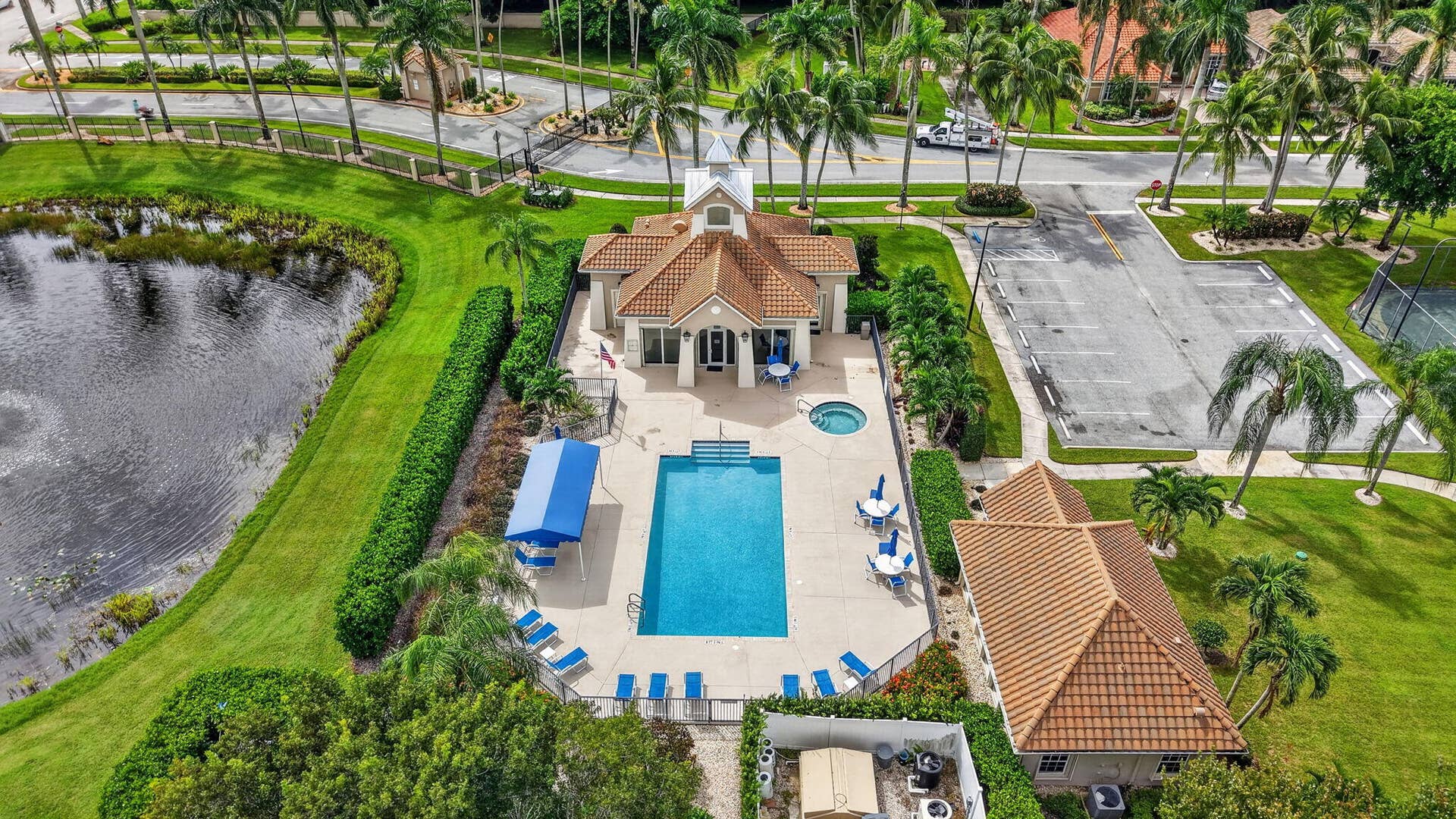 6610 Aston Lane, Boynton Beach, FL 33437 Community pool with an integrated spa, surrounded by a paved deck