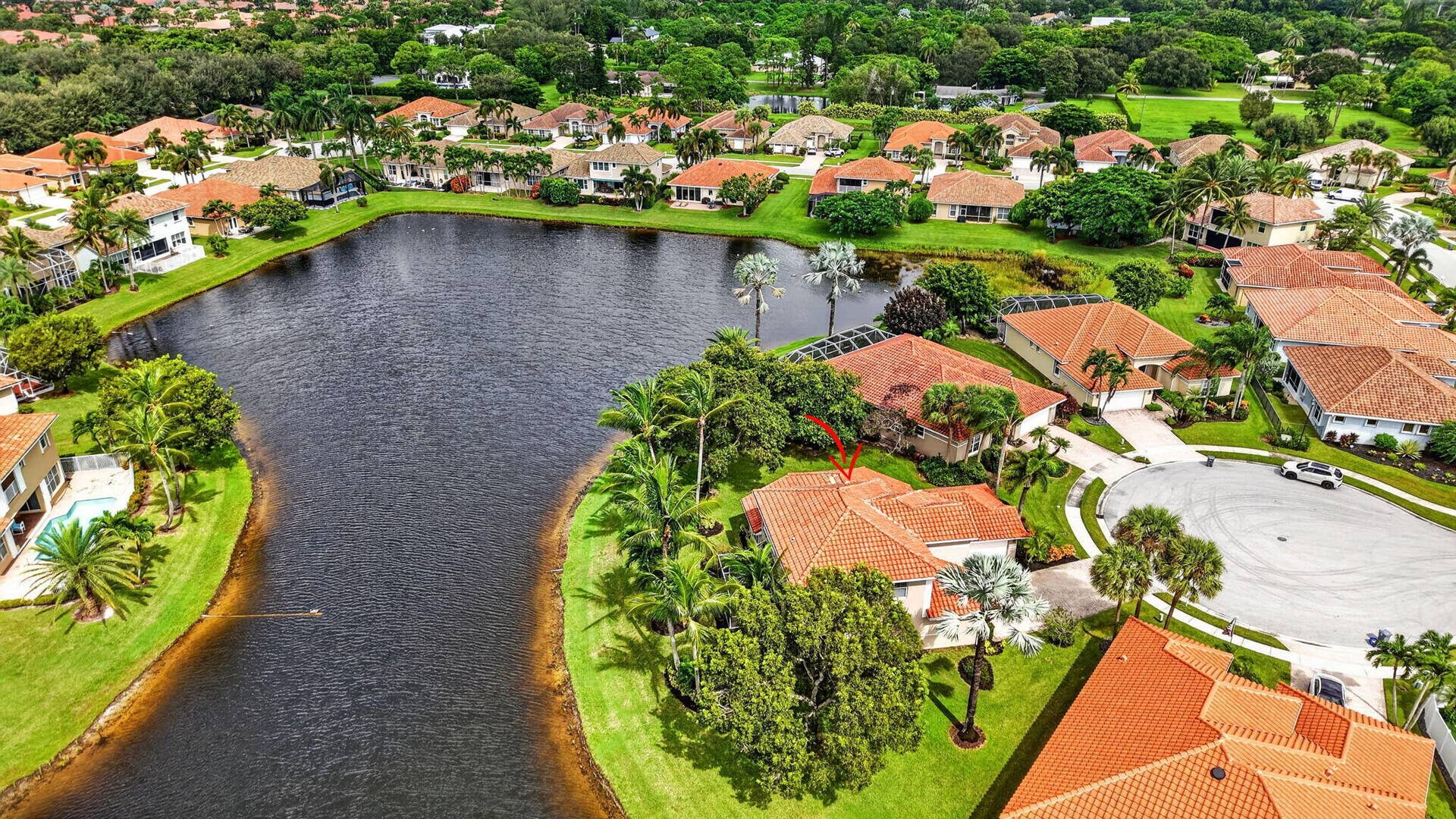 6610 Aston Lane, Boynton Beach, FL 33437 Aerial perspective of a property with a water feature, surrounded by mature trees and manicured lawns