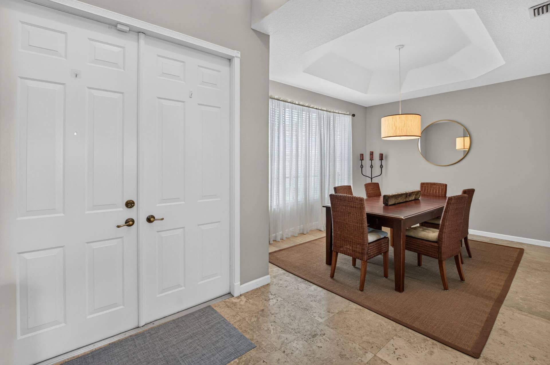 6610 Aston Lane, Boynton Beach, FL 33437 Tray ceiling with a drum pendant light fixture, creating a distinct dining area