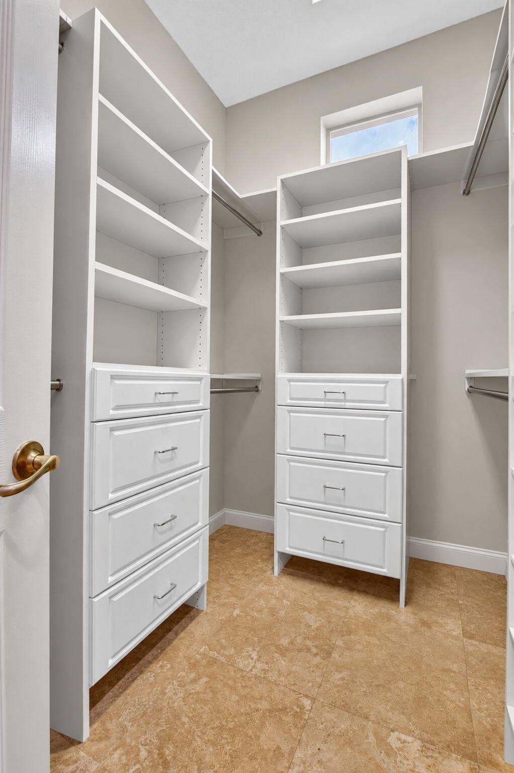 6610 Aston Lane, Boynton Beach, FL 33437 Custom closet system with white cabinetry, integrated shelving, and drawer storage