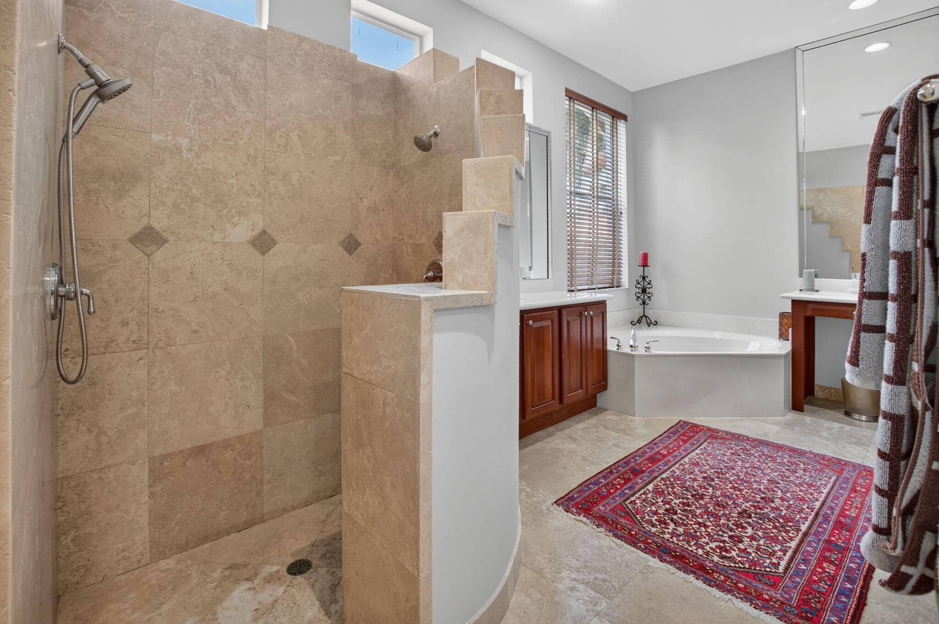6610 Aston Lane, Boynton Beach, FL 33437 Walk-in shower with natural stone tile, garden tub, double vanity with wood cabinetry, and tiled flooring