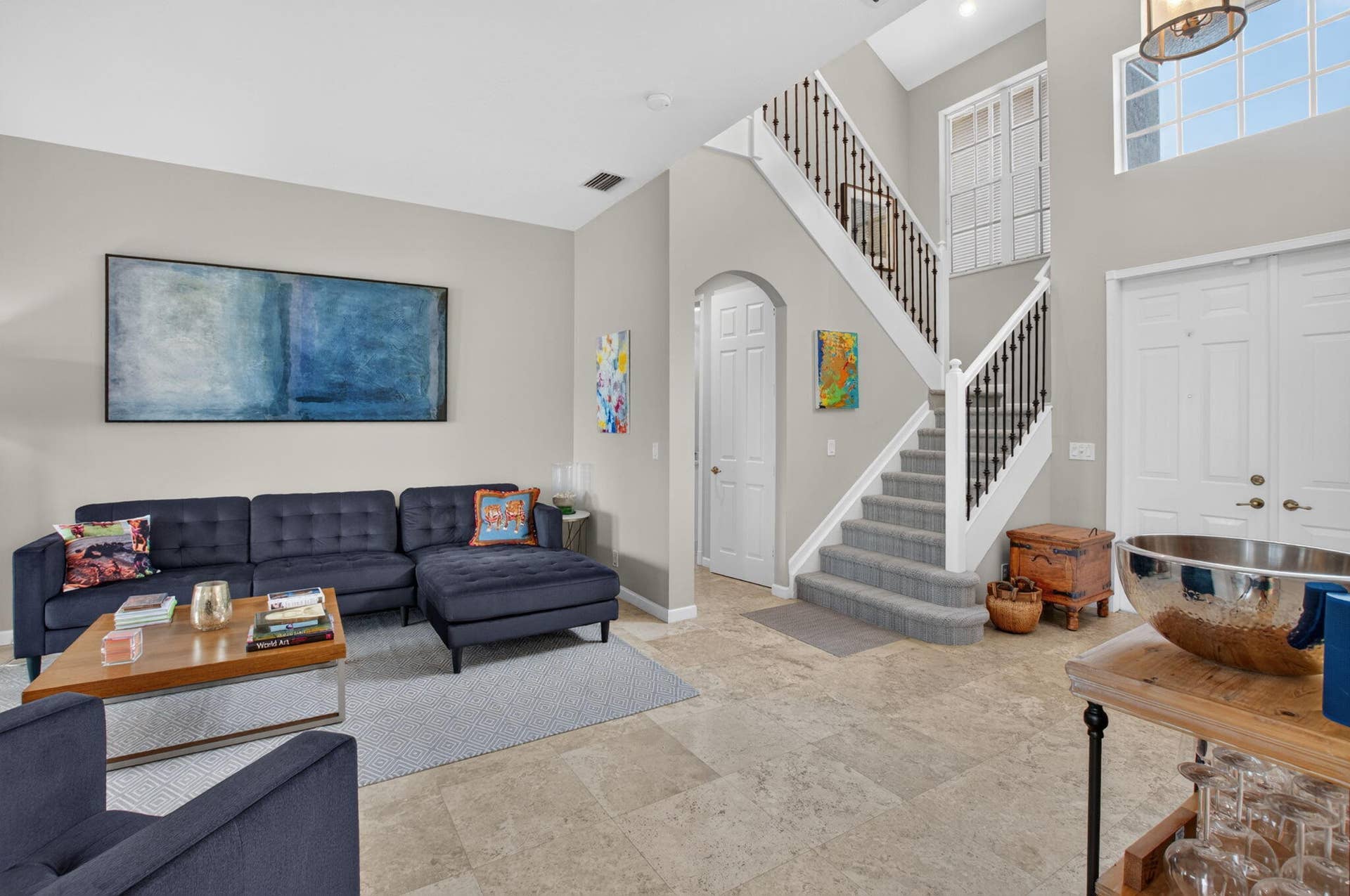 6610 Aston Lane, Boynton Beach, FL 33437 Two-story entry foyer with a grand staircase featuring dark iron balusters and light wood newel posts