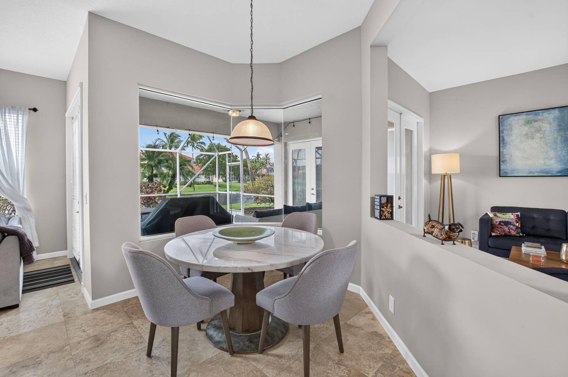 6610 Aston Lane, Boynton Beach, FL 33437 Stone-finish flooring, bay window, pendant lighting, half wall, and double French doors