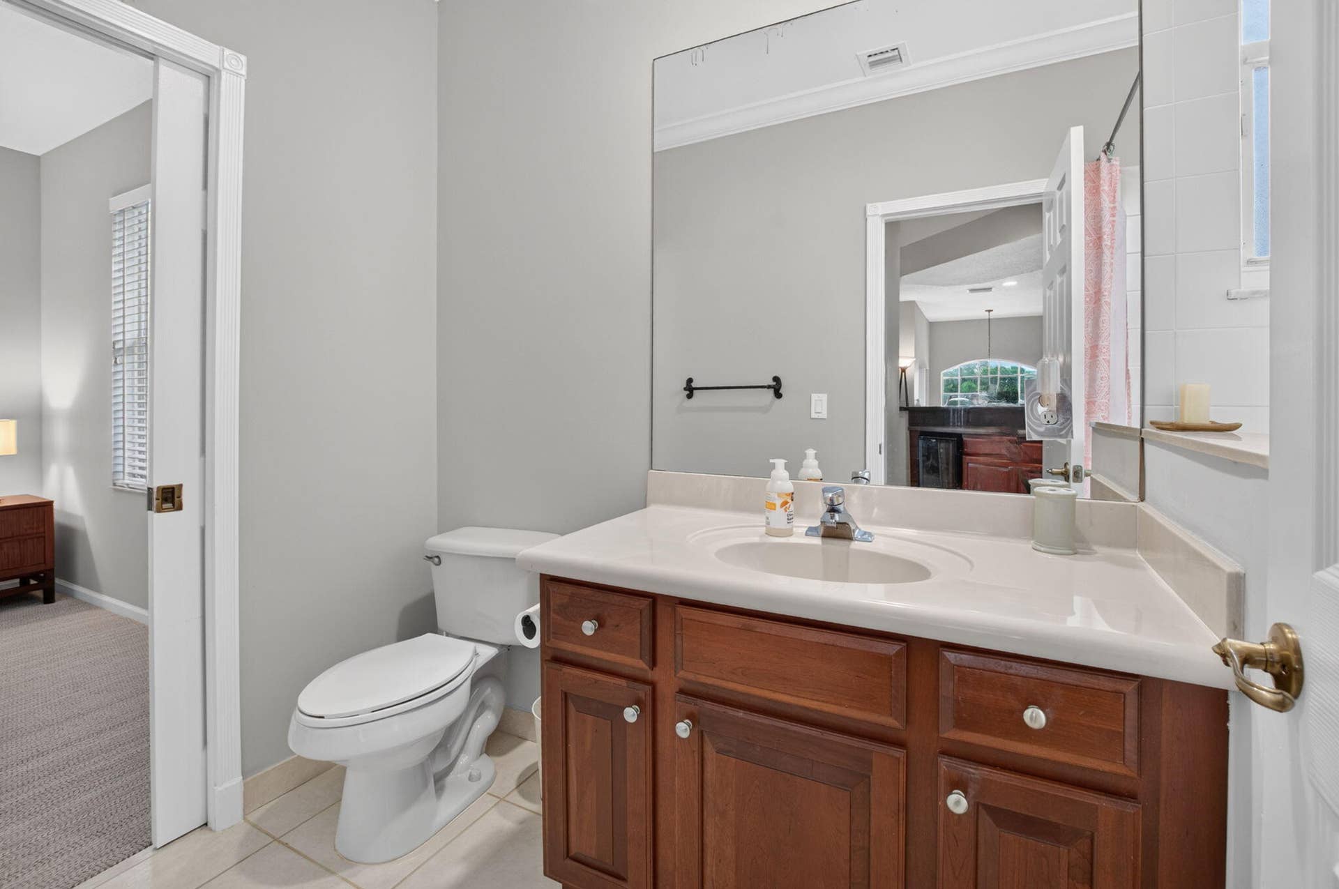 6610 Aston Lane, Boynton Beach, FL 33437 Hardwood vanity with a light-toned countertop, integrated sink, and large wall-mounted mirror