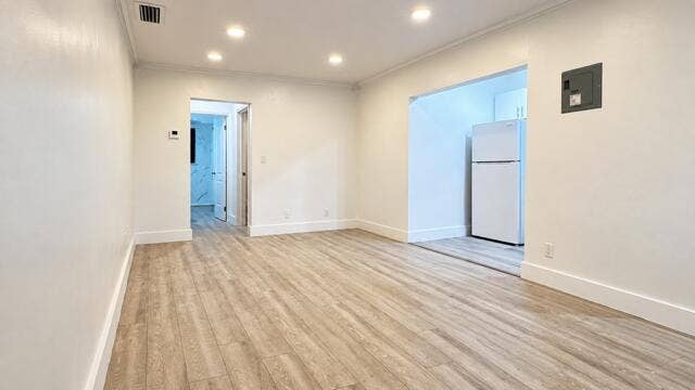 560 NE 15th Avenue, Fort Lauderdale, FL 33301 Recessed lighting illuminates the wood-finish flooring. Virtually staged.