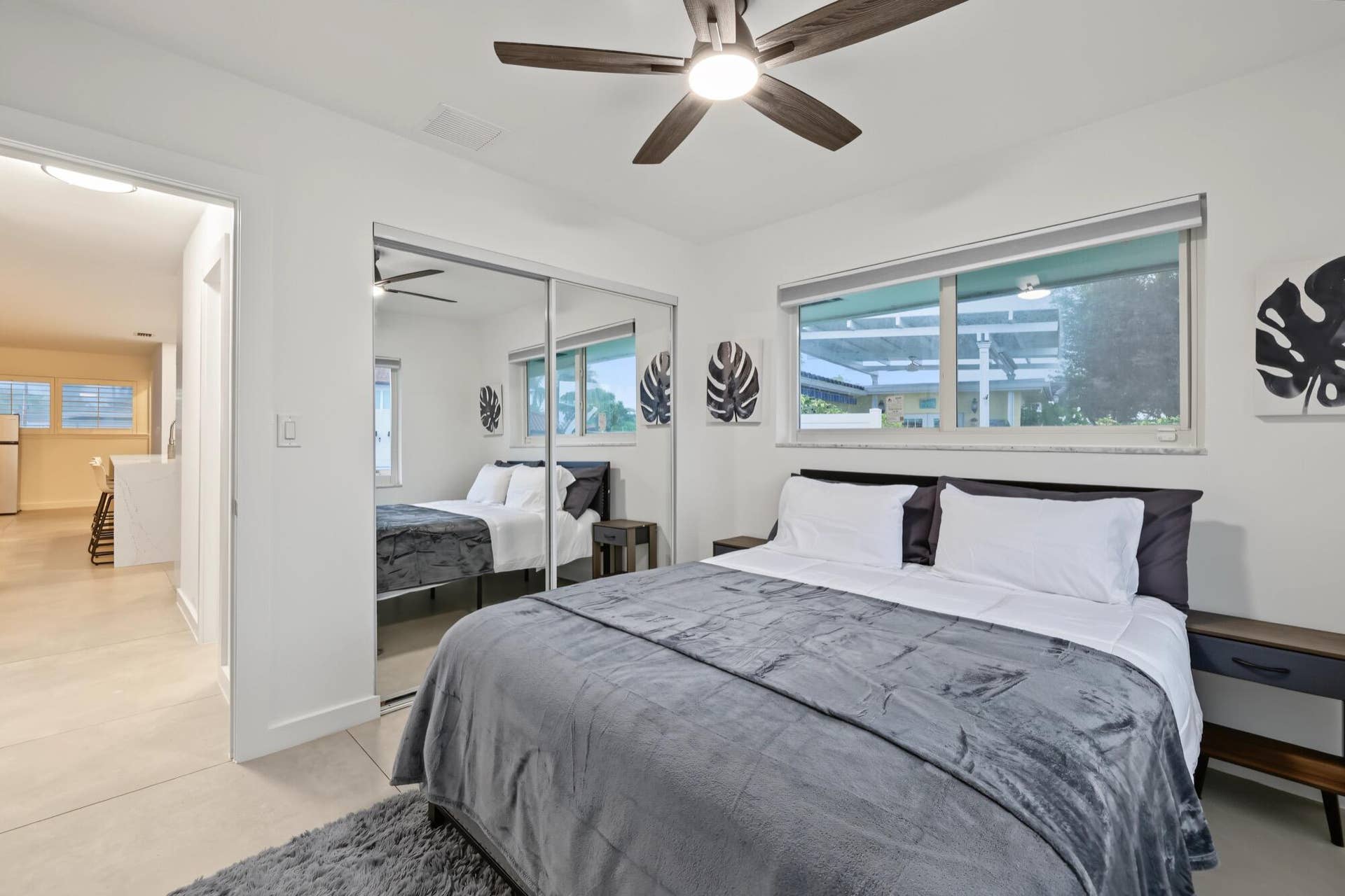 1311 SE 4TH Avenue, Pompano Beach, Pompano Beach, FL 33060 Recessed lighting with a ceiling fan, dual sliding mirror closet doors, and large windows with roller shades
