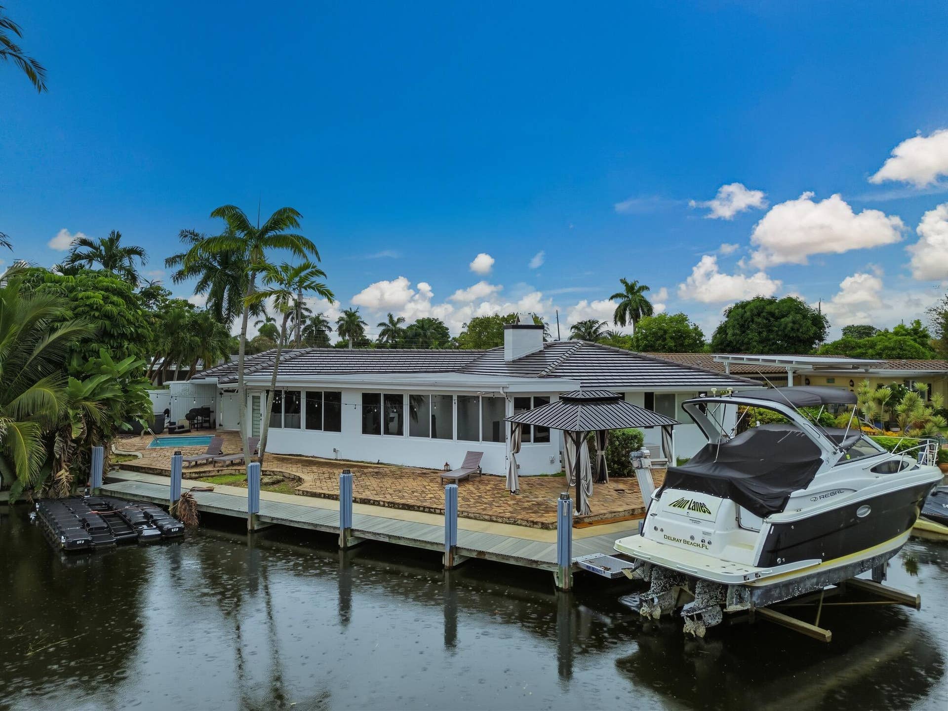 1311 SE 4TH Avenue, Pompano Beach, Pompano Beach, FL 33060 Waterfront property with a private dock featuring pilings, a boat lift, and an additional floating dock system