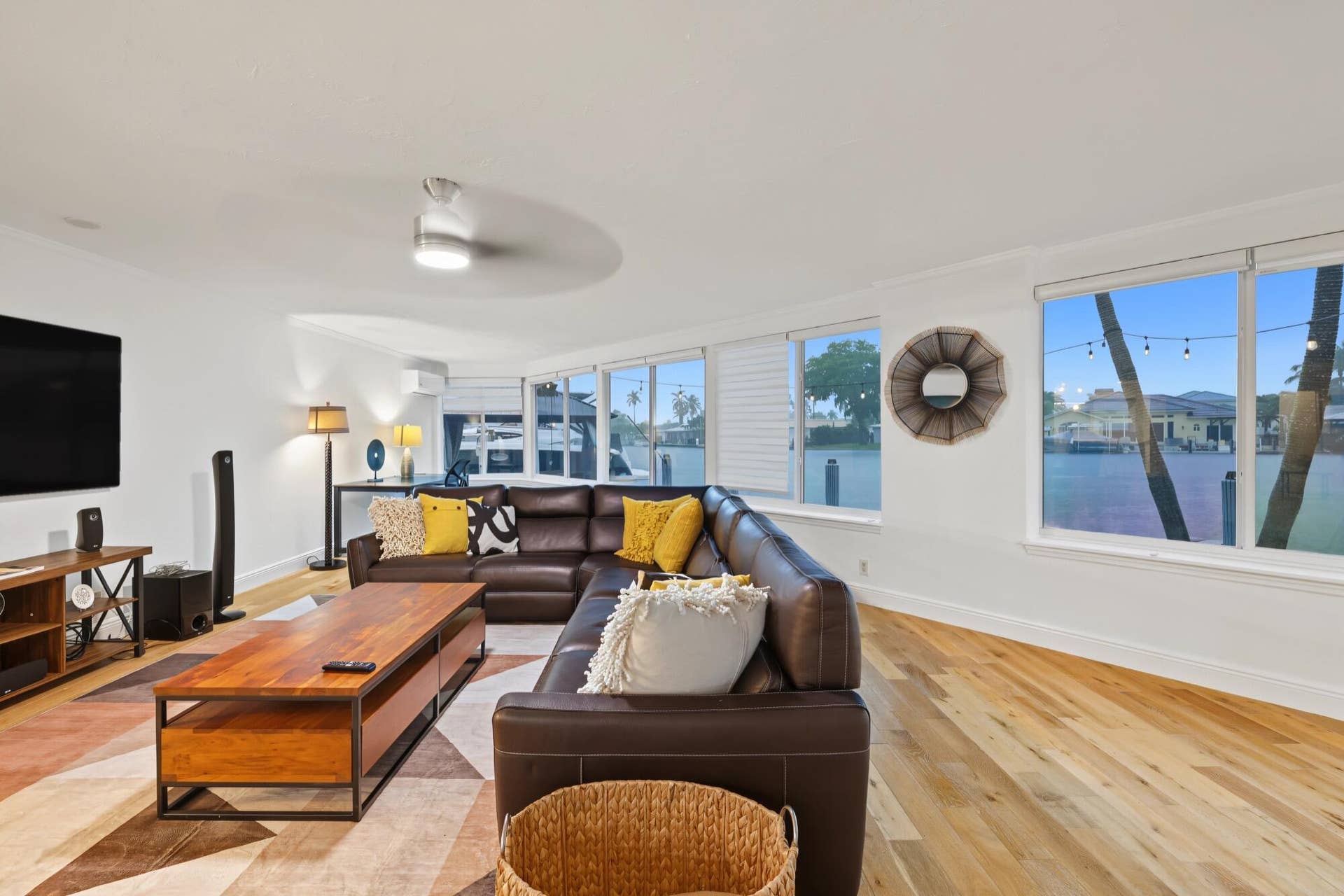 1311 SE 4TH Avenue, Pompano Beach, Pompano Beach, FL 33060 Light wood-finish flooring, recessed ceiling lighting, a ceiling fan, multiple windows with white trim, and white walls