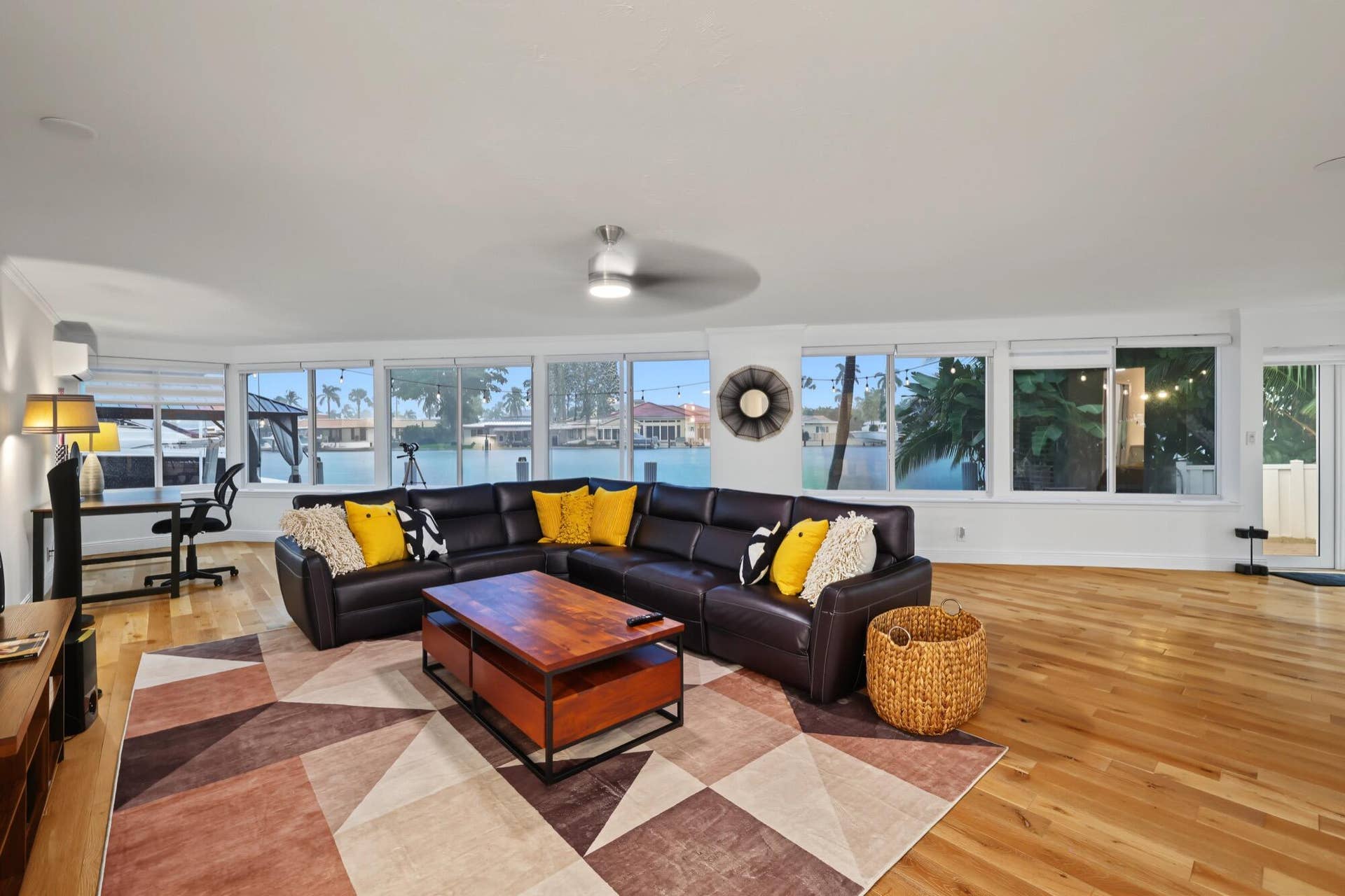 1311 SE 4TH Avenue, Pompano Beach, Pompano Beach, FL 33060 Expansive windows providing a water view, light wood-finish flooring, and a ceiling fan with integrated lighting