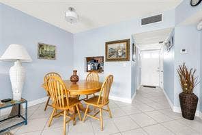 Recessed lighting, tile flooring, interior doorway, and wall-mounted air conditioning vent