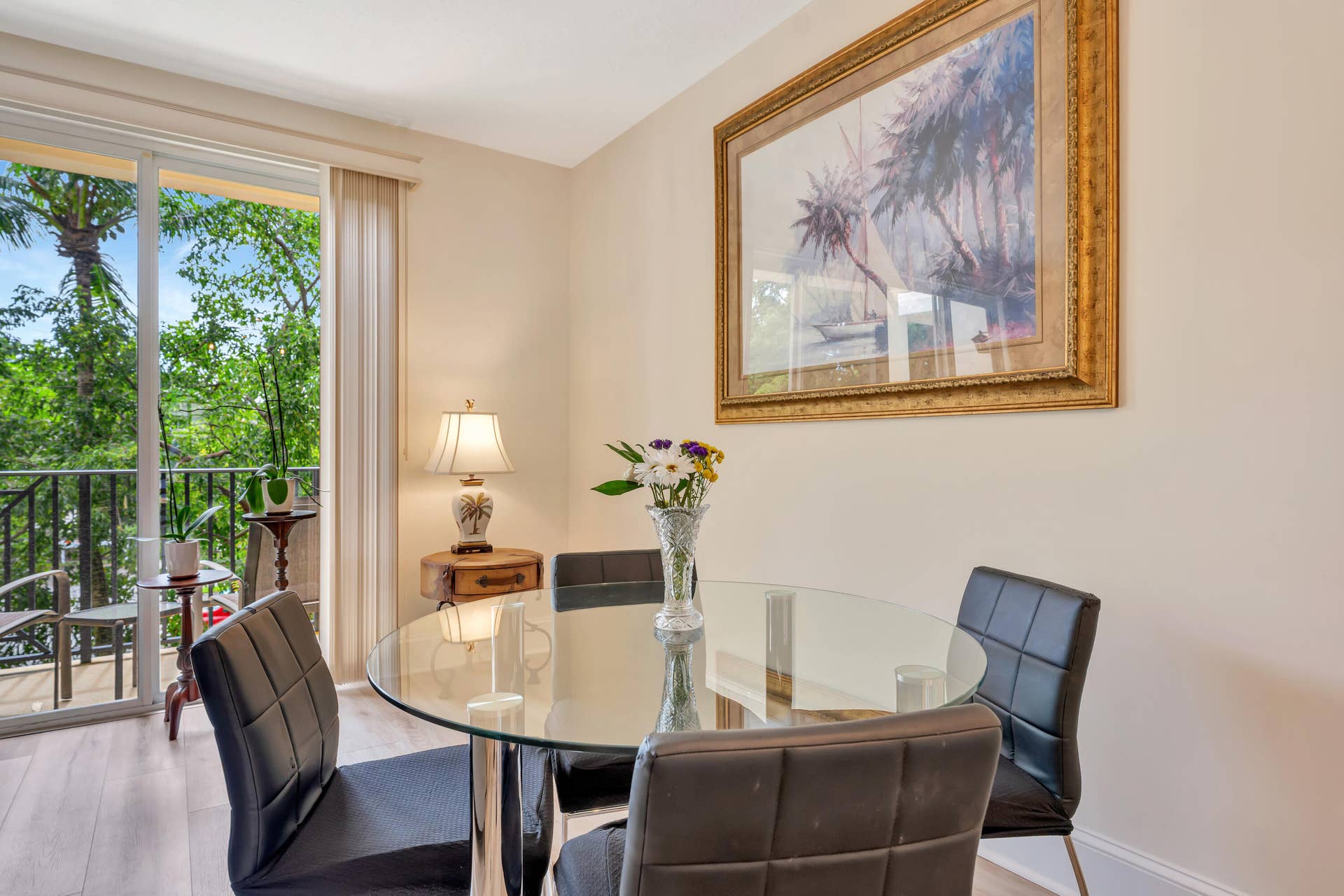 471 JUNO DUNES Way, Juno Beach, FL 33408 Light wood-finish flooring with a glass-paneled sliding door opening to a private balcony with a black metal railing