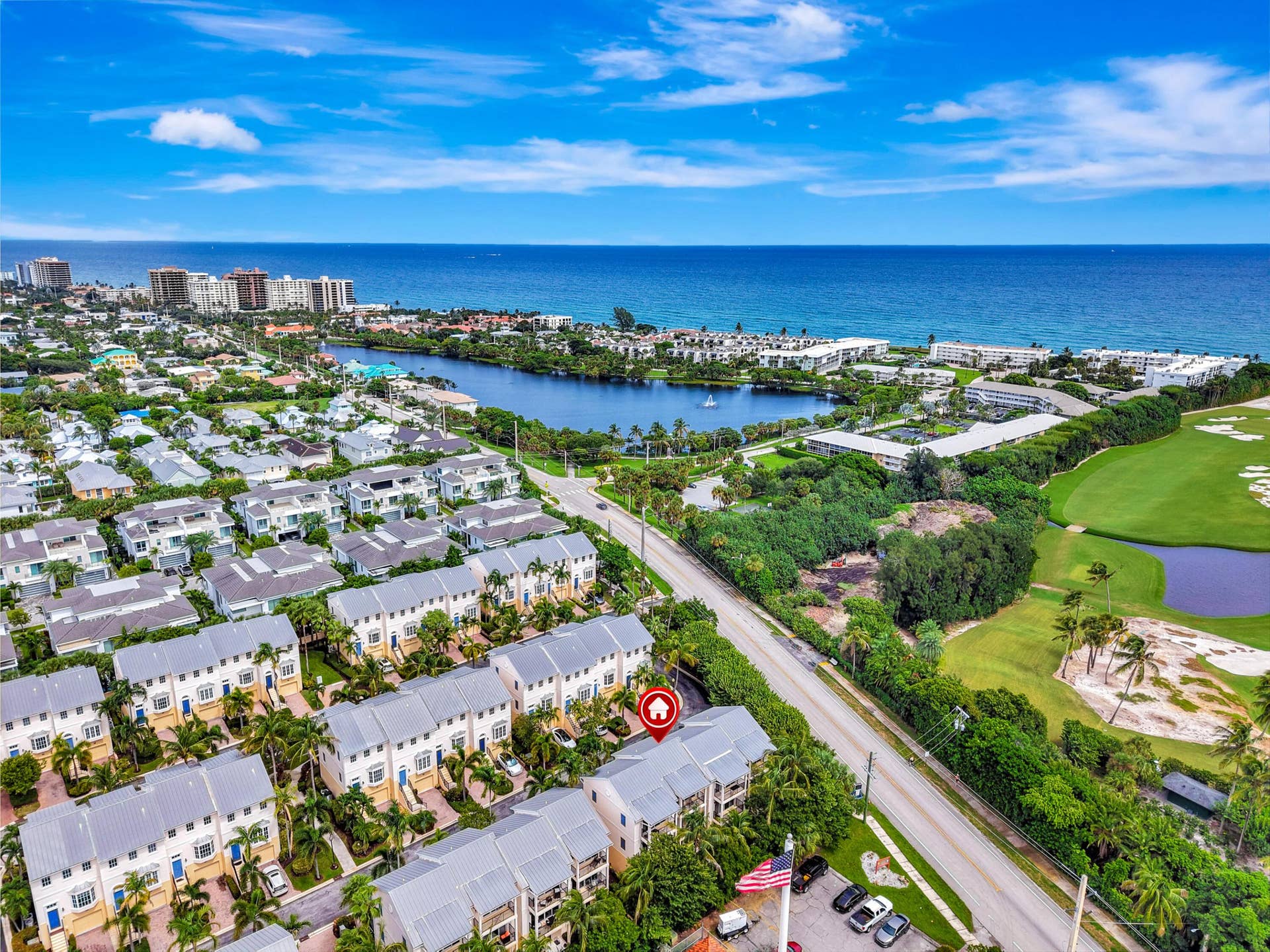 471 JUNO DUNES Way, Juno Beach, FL 33408 Aerial perspective showcasing a residential community, a water body, and a golf course